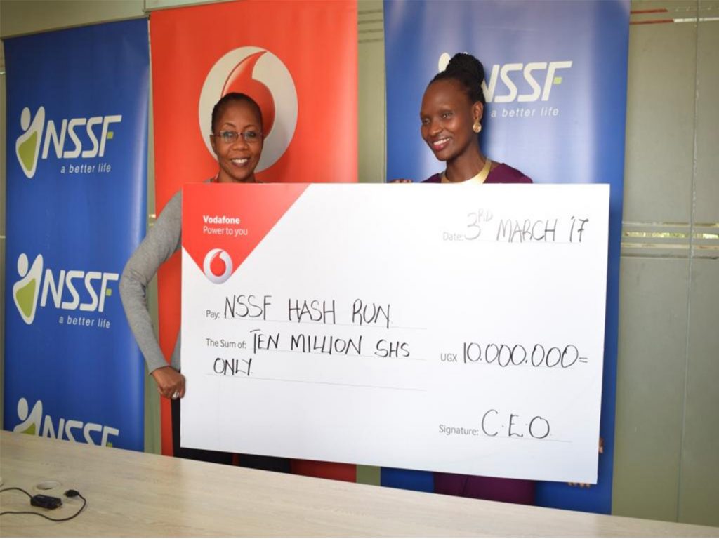 Vodafone Uganda Marketing Director, Ms. Progress Chisenga (left) handover dummy cheque worth Ugx10million to NSSF Marketing Director Barbara Teddy Arimi (right) at the NSSF offices recently towards the contribution of the second annual edition of the NSSF Kampala Hash Run which is scheduled to take place on Sunday 12th March, 2017.