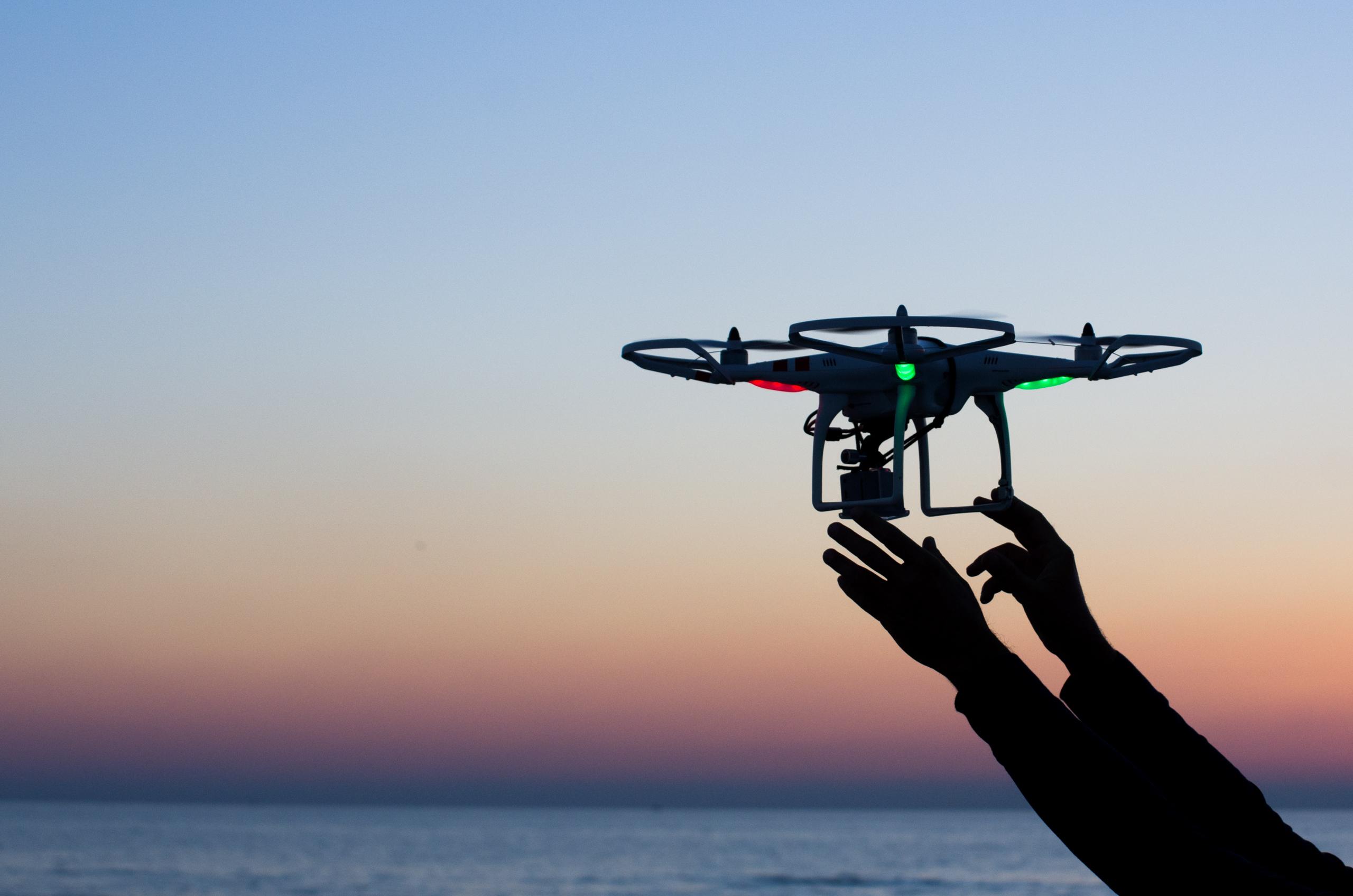 Viareggio, Italy - October 30, 2014: Drone takes off from the operator's hand with camera at sunset Quadcopter industry is told to be growing at triple digitsevery year, for a market expected to pass the 20 billion in the 2020. The dji is a chinese company leader of quadcopter industry, and the phantom is expected to be the top seller gift for christmas 2015. (Photo Credit)
