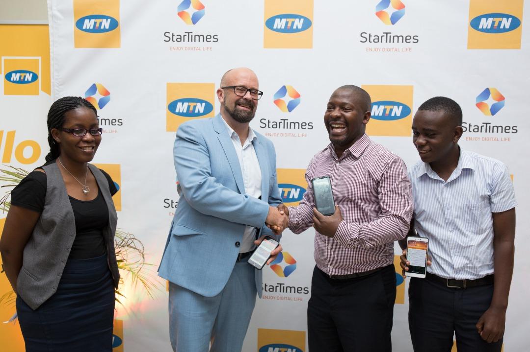 Chief Marketing Officer of MTN Uganda, Mr. Olivier Prentout shakes hands with Aldrine Nsubuga, Vice President and Brand & Marketing Director of StarTimes Uganda during the partnership announcement at the MTN Uganda HQ on Tuesday June, 26th 2018.
