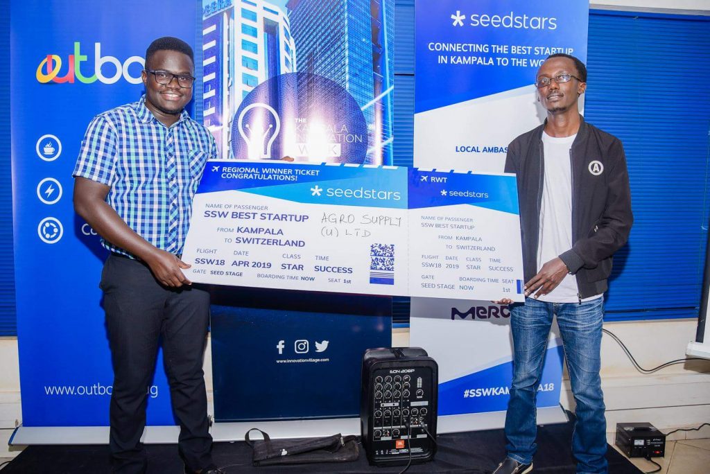 Ogwal Joseph; Founder and Chief Executive (Left), and Watson Atwine (Right); IT Specialist who represented the team, recivce their victory dummy air ticket at the Seedstar Kampala competition at Outbox Hub on Friday 24th, August 2018.