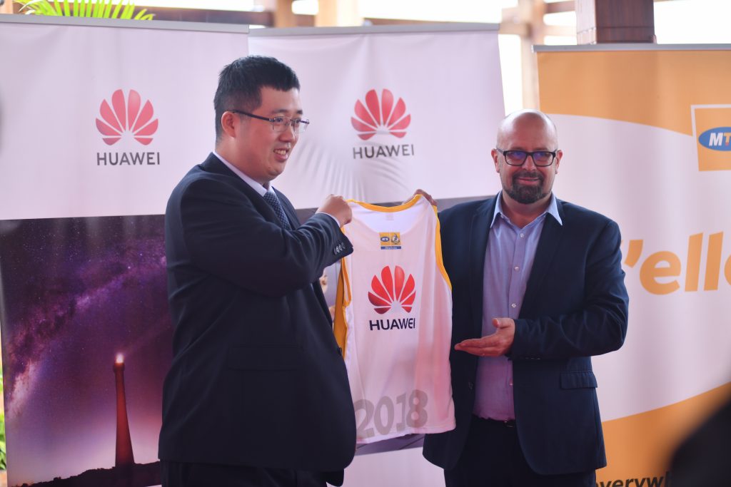 MTN Chief Marketing Officer Mr. Olivier Pentout handing over an MTN Marathon Kit to Huawei Uganda Managing Director Mr. Liujiawei.