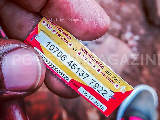 A customer seen holding a scratch/airtime card of UGX2,000 from Airtel Uganda. The scratch/airtime cards are to be terminated for customers to resort to using electronic payments to purchase their cards. (PC TECH MAGAZINE/Olupot Nathan Ernest)
