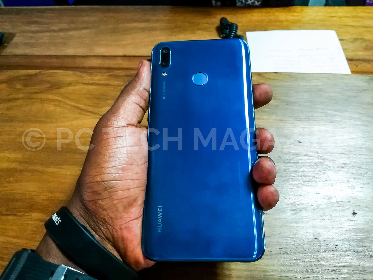 A person pictured holding the Huawei Y9 (2019) smartphone in a sapphire blue color option. (Photo - PC TECH MAGAZINE/Olupot Nathan Ernest)