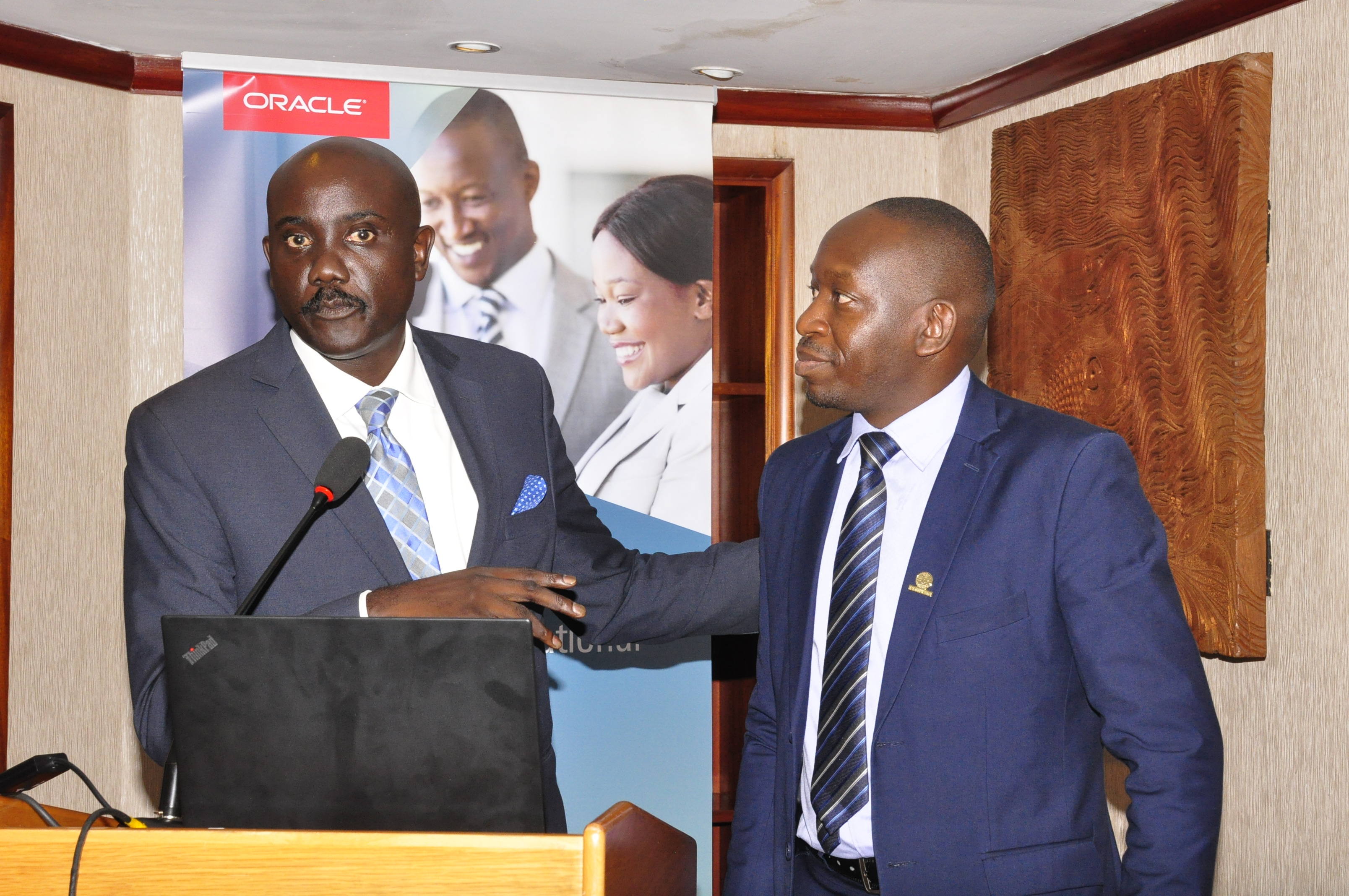 Dr. Tumubweine Twinemanzi, the Executive Director Supervision, at Bank of Uganda (BoU) (L) and Oracle’s Byron Osiro, the Oracle Senior Cloud Platform Manager, East Africa (R) during the first Oracle-Raxio executive roundtable event at Serena Kampala Hotel, on March 6th 2019