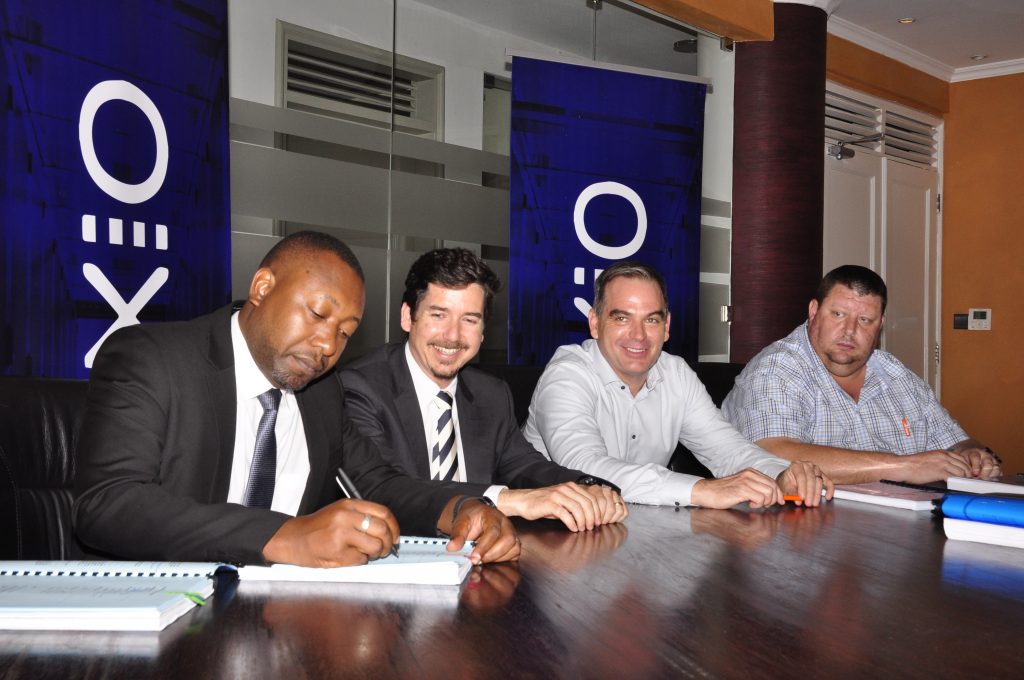 (Left-Right): James Byaruhanga, the Raxio General Manager, signs the contract as Robert Mullins, Director, Raxio as Roko Managing Director, Mark Koehler and Willie Swanepoel the Director, Roko Construction look on. 