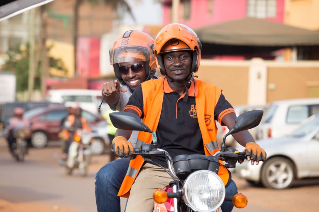 A passenger pictured happy on a Safeboda. FILE PHOTO