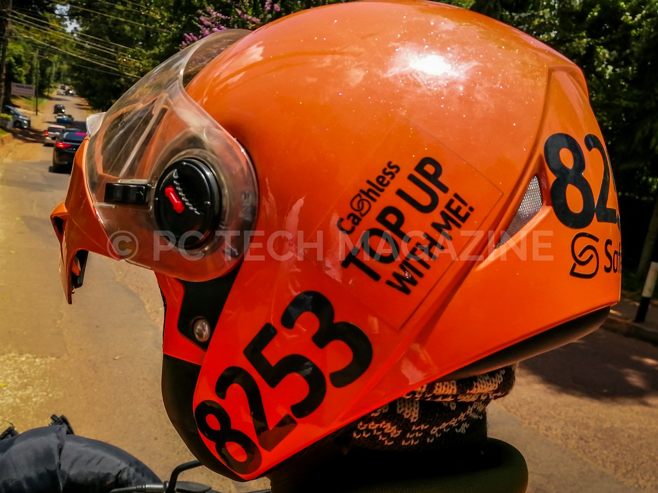 Safeboda riders permitted to sale credit to their customers have a sticker that reads "Cashless Top With Me" on their helmet | Photo by PC TECH MAGAZINE/Olupot Nathan Ernest.