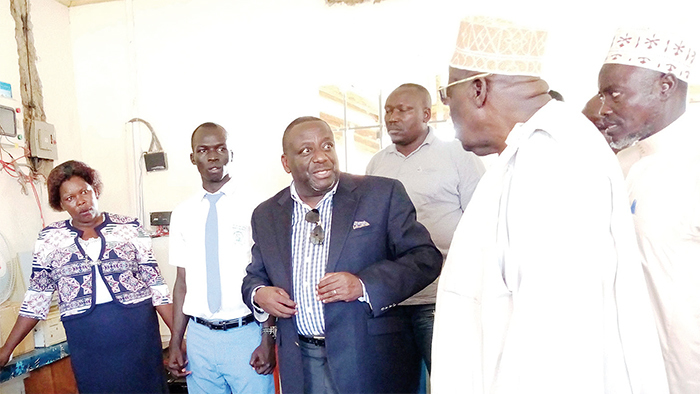 Nyombi Tembo (third left) speaking to the Deputy Prime Minister; Gen. Moses Ali at the Bezza Al Hijji Secondary School new ICT laboratory | File Photo/New Vision.