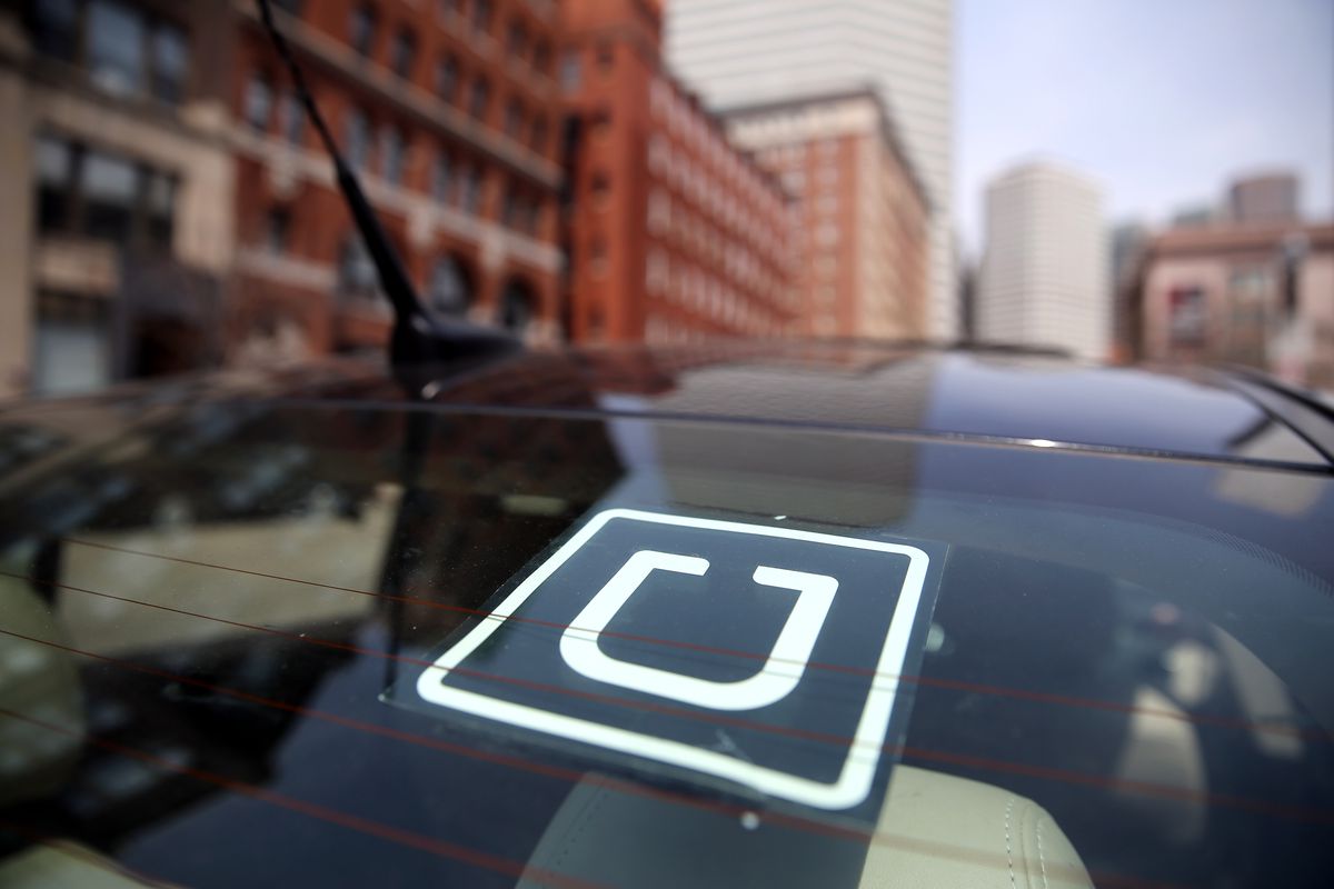 The Uber logo is displayed on the window of a vehicle | File Photo/Curbed Boston via Getty Images.