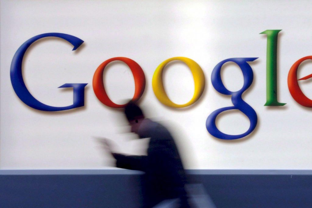 A man passes by a Google logo. Photo: EPA-EFE