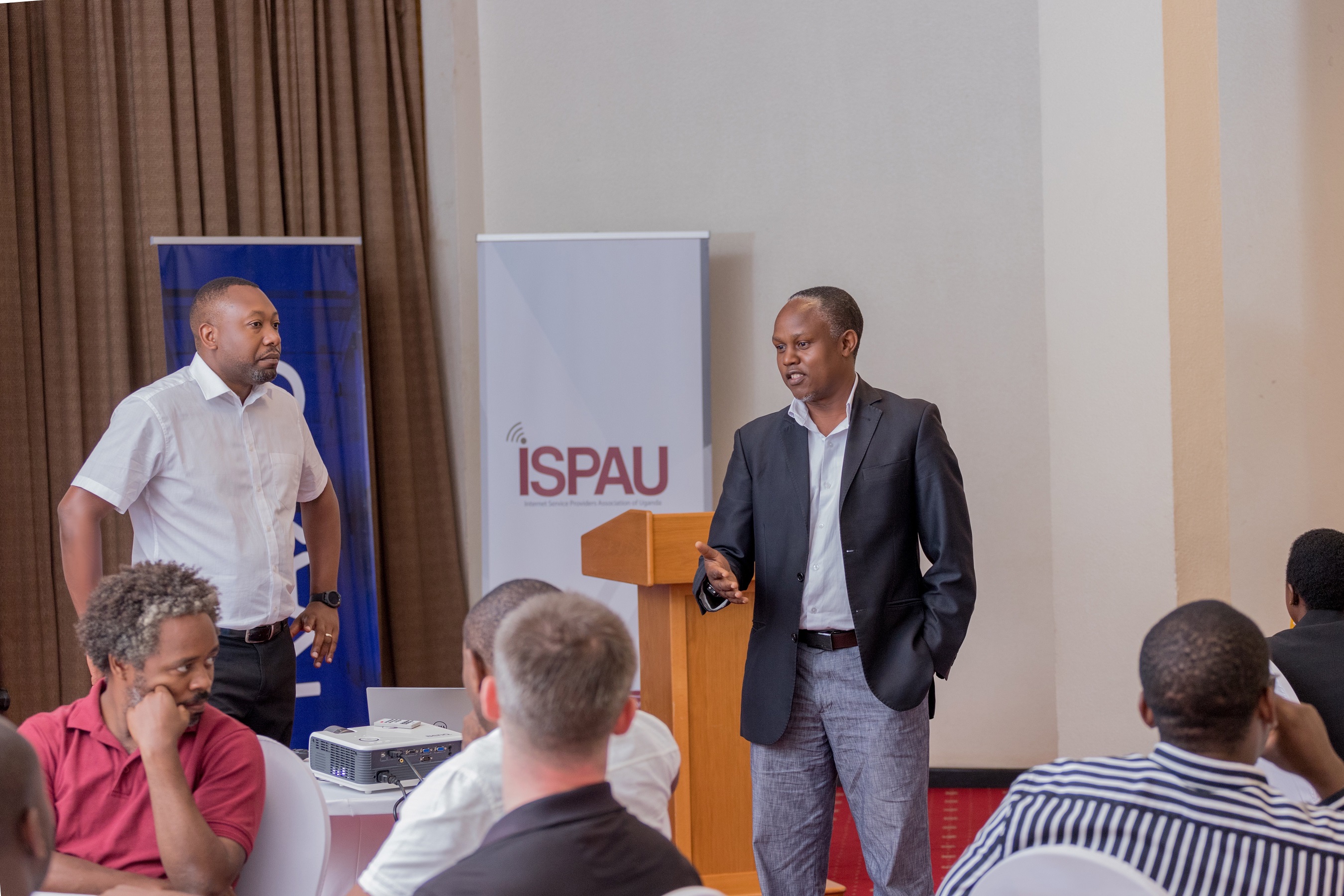ISPAU Chairman; Godfrey Sserwamukoko (R), addressing ISPAU and the press on the need for synerges between Carrier Neutral Data Centres and ISPs/Telco's while Raxio General Manager; James Byaruhanga (L) looks on.