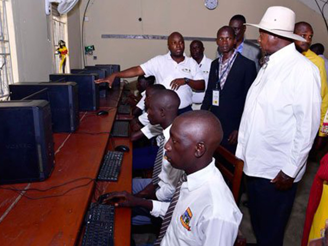 NITA’s Director eGovernment services; Peter Kahigi briefs President Museveni on the new installed ICT infrastructure at St Charles secondary school one of the beneficiaries of the project. Photo/PPU . Huawei
