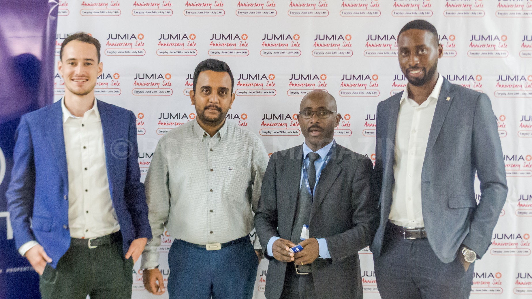 Paul Tesar, Head of Growth Jumia Uganda (L) and Ron Kawamara, Jumia Uganda CEO (R) pose for a group photo with their partners from Liberty Insurance (2nd right) and Transtel (2nd left) at the launch of their anniversary celebration at Hotel Africana on Tuesday 18th, June 2019.