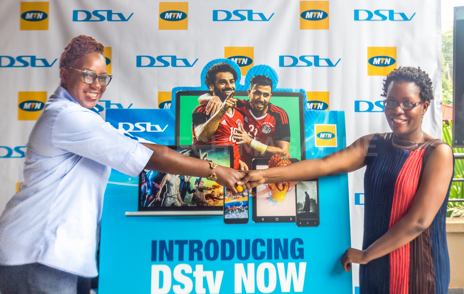 MultiChoice Uganda Head of Customer Experience, Ms. Patrica Kiconco (L) and MTN Uganda's Senior Manager for Digital; Ms. Suzan Kayemba (R) shake hands after the launch of DStv Now MTN Data Bundles at MultiChoice Uganda head offices is Kololo on Monday 24th, June 2019.