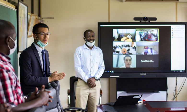 Huawei Executive Director Enterprise Business group Mr. Bai Chengyu and Mr. Natumanya Edmund; I.T specialist at Huawei Uganda demonstrating how the video conferencing ICT equipment they donated to the Ministry of Health will assist in the battle against COVID-19.