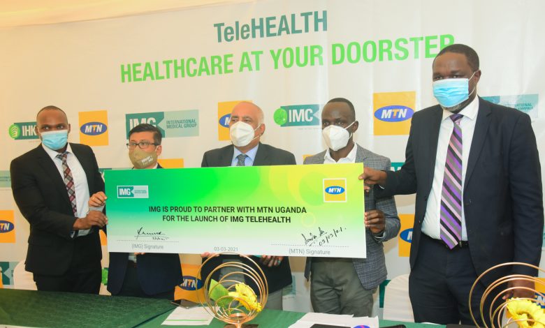 MTN Uganda's Chief Marketing Officer; Somdev Sen (2nd from left) poses for a photo with the IMG staff after signing the partnership agreement to offer telemedicine services. (COURTESY PHOTO)