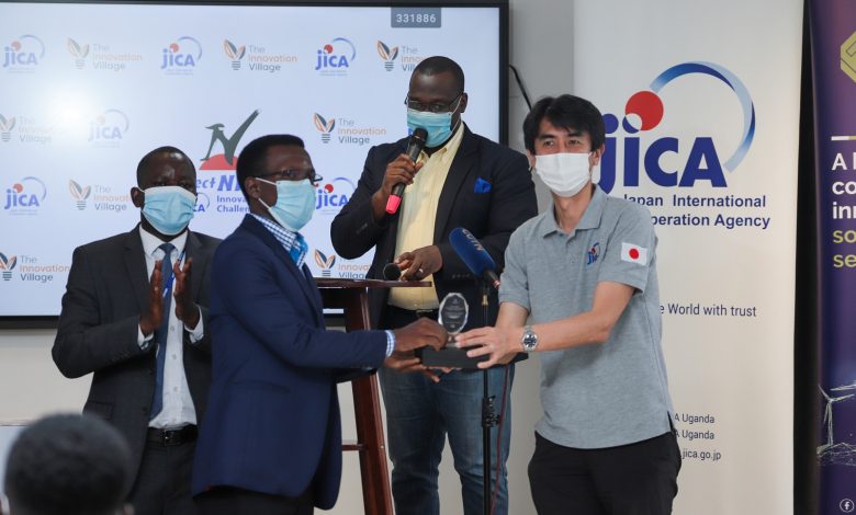 Innocent Menyo (left) founder M-Scan receives an award from Fukase Yutaka (right) Chief Representative JICA Uganda after emerging the best innovative solution in Africa in the NINJA COVID-19 Response and Recovery Business Challenge. (COURTESY PHOTO)