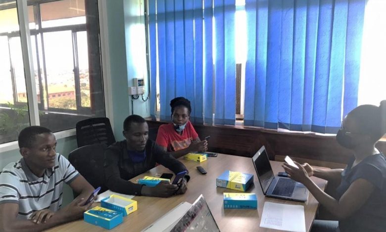 Sunbird AI Software Engineer, Lydia Sanyu Naggayi (r) training the noise collection agents on how to use the artificial intelligence to capture noise levels. (PHOTO: Sunbird)