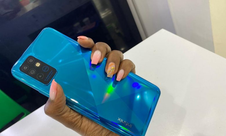 A customer pictured holding the Infinix NOTE 8 launched in November 2020. (FILE PHOTO)