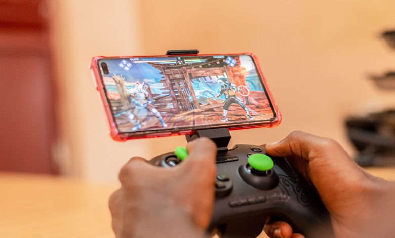 A gamer pictured playing a game on his mobile phone. (PHOTO: Katende Erick and Blaise Wayinda)