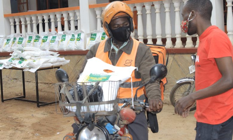 A safeboda driver receives maize flour and beans in an initiative of SafeBoda in partnership with Yuvraj TVs. (COURTESY PHOTO)