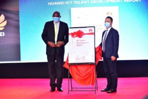 Minister of ICT and National Guidance, Hon. Dr. Chris Baryomunsi (Left) and Managing Director Huawei Uganda Mr. Gao Fei (Right) pose for a photo after revealing the Huawei ICT Talent Development Report.