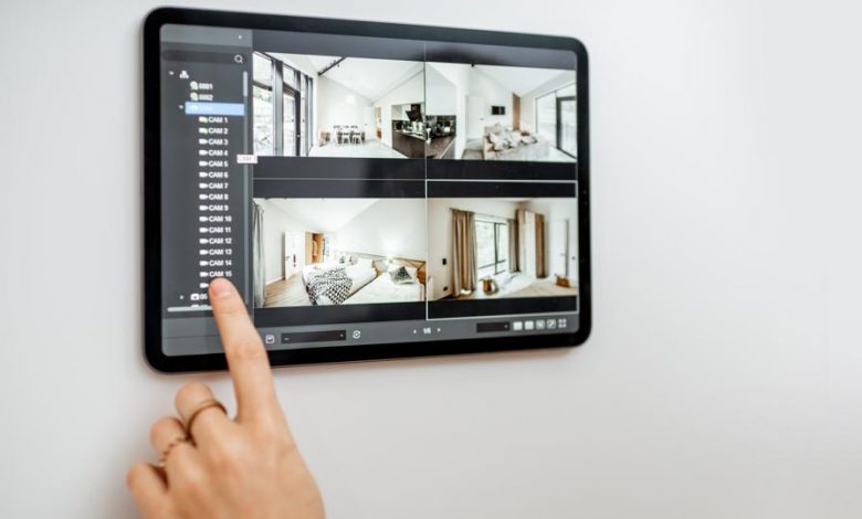 A person pictured looking on camera system installed at their home. (COURTESY PHOTO)