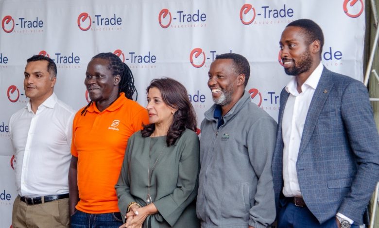 Members of the E-Trade Association of Uganda pose for a group photo at the launch of the petition at Fairway Hotel.