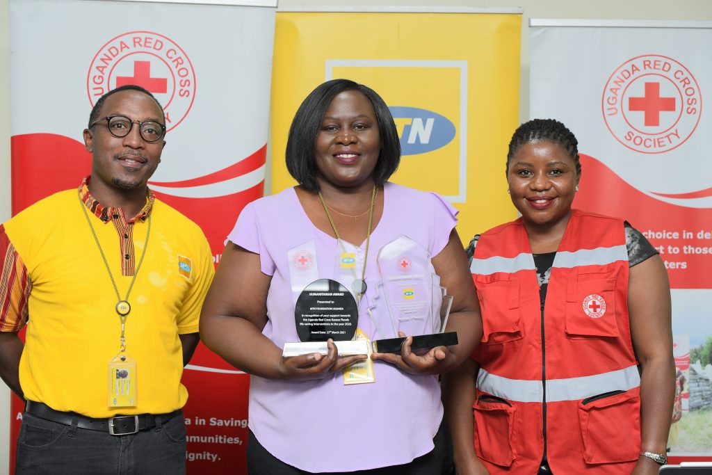 MTN Uganda's General Manager; Ms. Enid Edroma (C), Senior Manager of MTN Foundation; Bryan Mbasa (L), and (R) at Uganda Red Cross Society pose for a group photo after MTN Foundation received the Humanitarian Award.