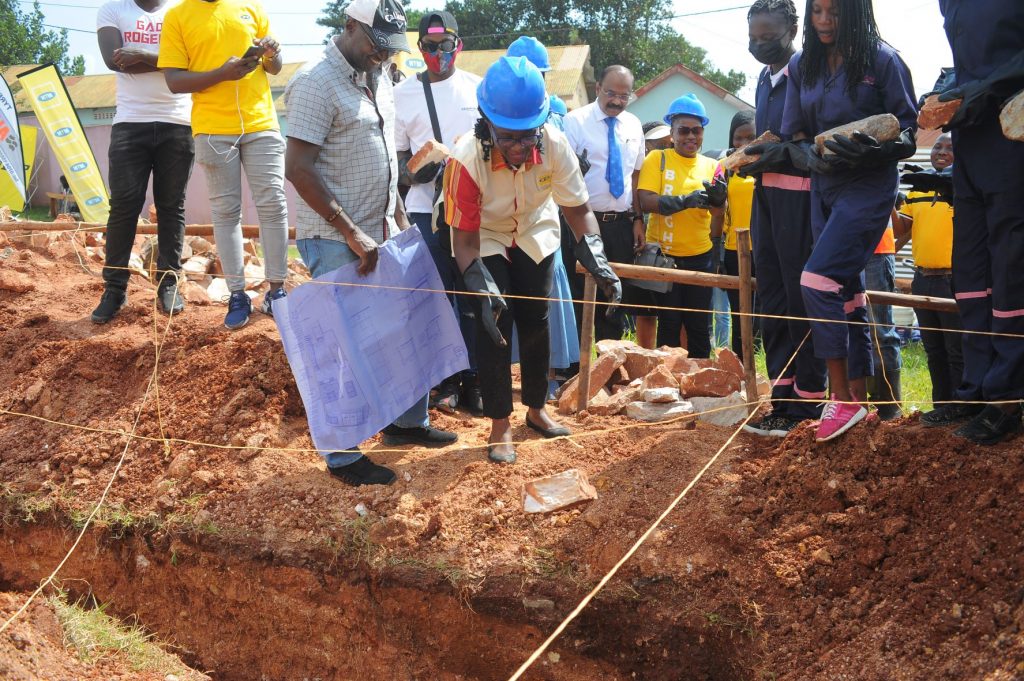MTN Uganda General Manager for Customer Experience, Dorcas Muhwezi lays the foundation to the construction of a facility with the capacity to train 400 girls in vocational programs.