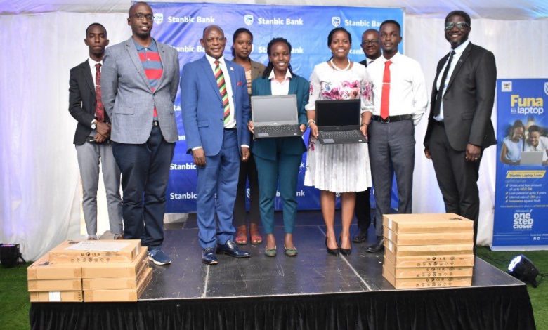 VC Makerere University; Prof. Barnabas Nawangwe (2nd left), Shamim Nambassa; Guild President of Makerere University (center), Stanbic Bank Uganda CEO; Anne Juuko (2nd right) and Sam Mwogeza (right); Executive Head of Consumer & High Net Worth Products at Stanbic Bank Uganda pose for a group photo with other officials. (COURTESY PHOTO)