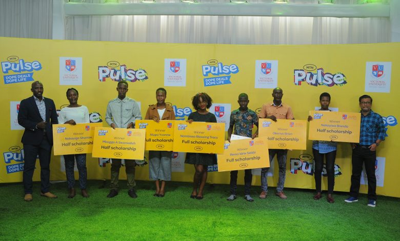 Some of the winners display their scholarships during the awarding ceremony at the MTN Uganda headquarters.