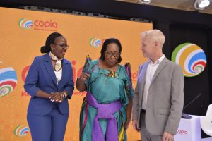 The State Minister of ICT and National Guidance, Hon. Juliet Nabbosa Ssebugwawo (center) shares a ligt moment with Tim Steel (right), CEO of Copia Global and Diana Adeyemi (left) the Country Director of Copia Uganda.
