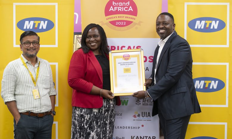 Joseph Kanyamunyu (right), CEO of The Publicist East Africa hands over the Most Admired Brand award to Enid Edroma, MTN Uganda General Manager Corporate Services as Somdev Sen (left) MTN Uganda CMO looks on.