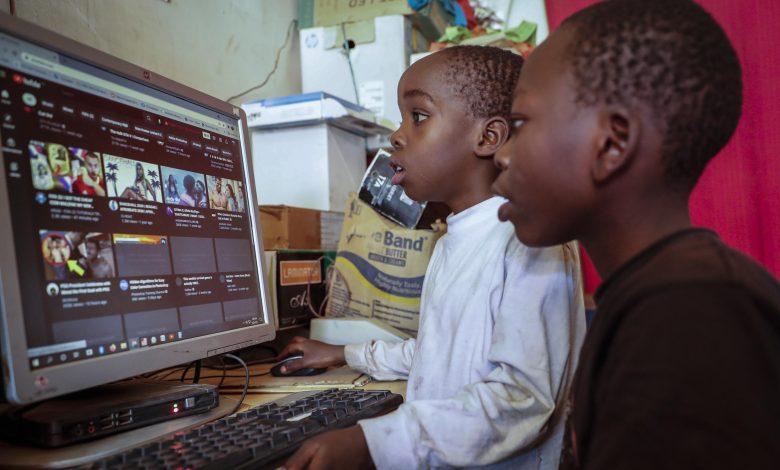 Two young boys use a computer at an internet cafe in the low-income Kibera neighborhood of Nairobi, Kenya Wednesday, Sept. 29, 2021. Instead of serving Africa's internet development, millions of internet addresses reserved for Africa have been waylaid, some fraudulently, including in insider machinations linked to a former top employee of the nonprofit that assigns the continent's addresses. (AP Photo/Brian Inganga)