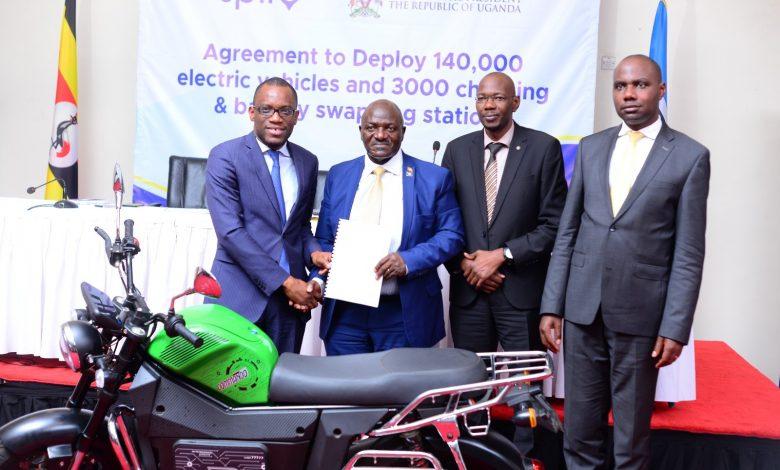 Shegun Adjadi Bakari, the CEO of SPIRO and partner at the African Fund for Transformation and Industrialization (L), Gen. Katumba Wamala, Minister of Works and Transportation (2nd Left) shake hands after signing MoU to deploy electric bikes in Uganda.