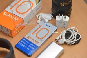 Tecno Spark 10 Pro outside the box with its accessories including a charging cable, 18-watt charging brick, standard 3.5mm headsets, and a transparent silicone phone case. PHOTO: PC Tech Magazine