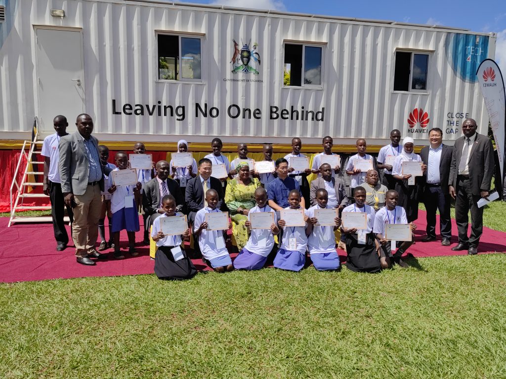 Some of the DigiTruck beneficiaries pose for a group photo with the third deputy Prime Minister, Rt. Hon. Rukia Nakadama and officials from Huawei.
