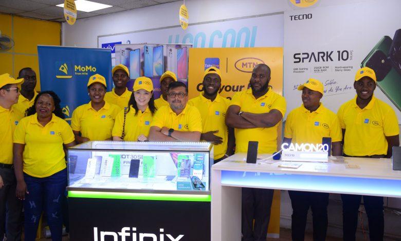MTN Uganda and TakeNow teams pose for a group photo after annoucing their partnership, unveiling new phones on the Mpola Mpola payment scheme.