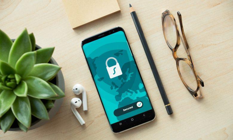 A smartphone with a shield overlay, highlighting mobile security. PHOTO: Dan Nelson/Unsplash