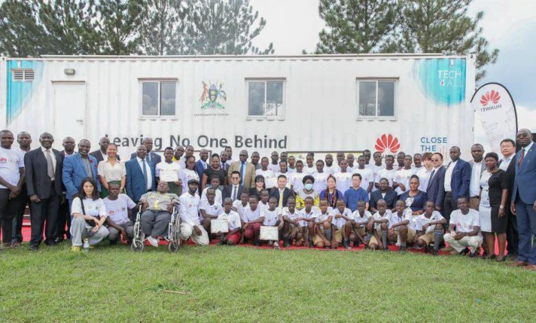 Some of the certified students from the first cohort of digital skills training in the Huawei DigiTruck Project from the Busoga sub-region pose for a group photo with the VP, Jessica Alupo, Rebecca Kadaga, Amb. Zhang Li Zhong and other delegates.
