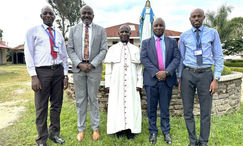 Cente-Tech’s CTO, Peter Kahiigi (2nd from right) and other Cente-Tech officials pose for a group with Bishop Robert Muhiirwa, Fort Portal Catholic Diocese. COURTESY PHOTO