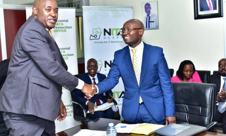 Minister of ICT and National Gudiance, Hon. Chris Baryomunsi (left) congratulating Alexander Kibandama on his appointment as the new Chairperson Board of Directors, NITA-U.