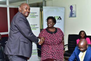 Minister of ICT and National Gudiance, Hon. Chris Baryomunsi (left) congratulating Dr. Theodora Mondo, new NITA-U Board member.