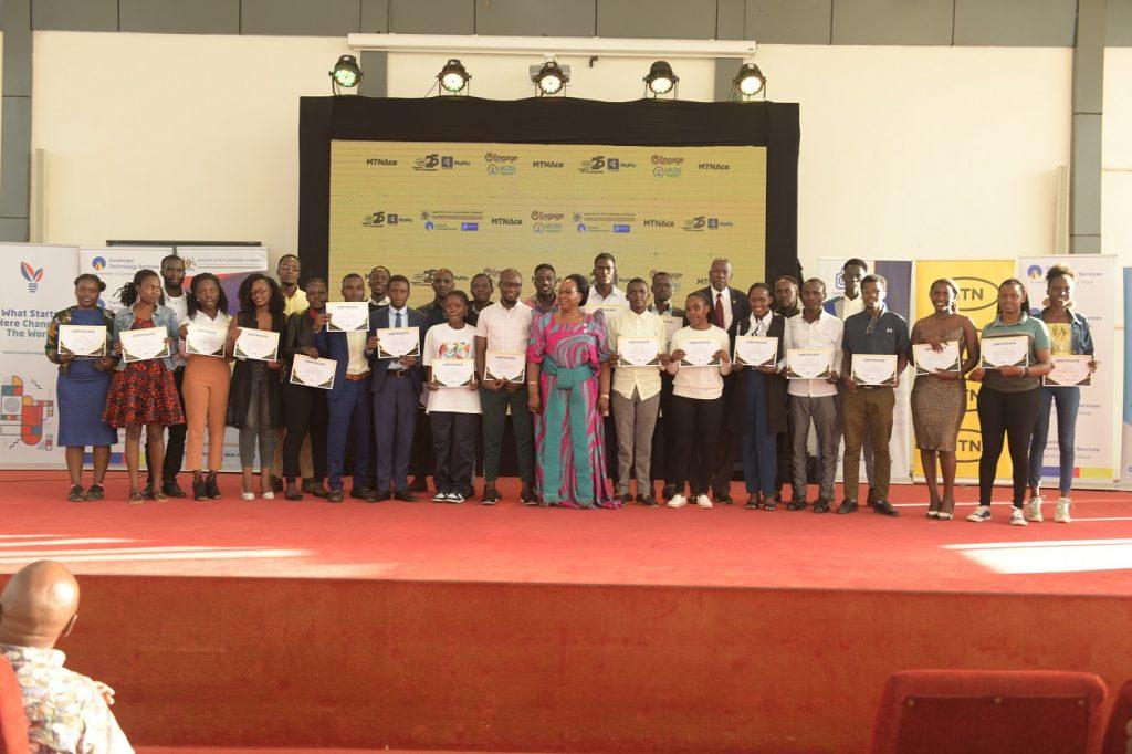 Minister of State for ICT and National Guidance, Joyce Ssebugwawo (In a gomesi), celebrates with the inaugural MTN ACE Program graduates at the National ICT Hub in Nakawa, September 7, 2023.