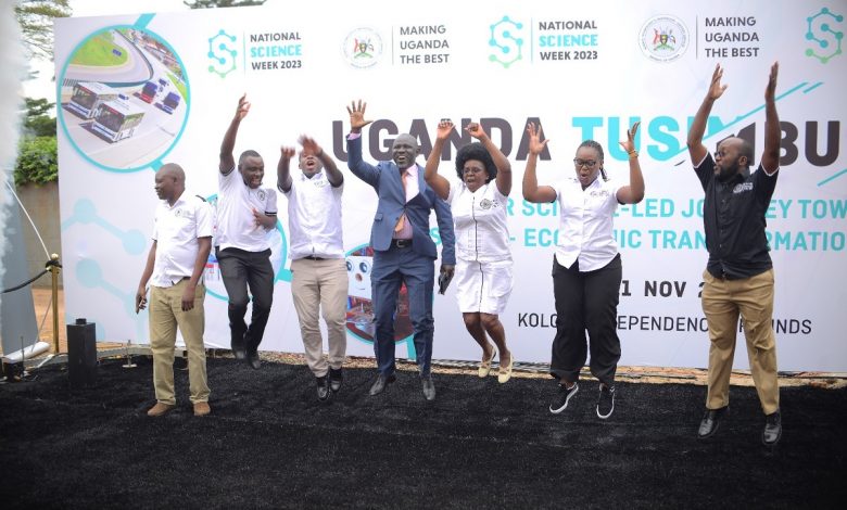 Hon. Dr. Monica Musenero Masanza (3rd from right), the Minister for Science, Technology & Innovation with other officials and partners jump as they launch the 2023 National Science week set to happen from 6-11, November.