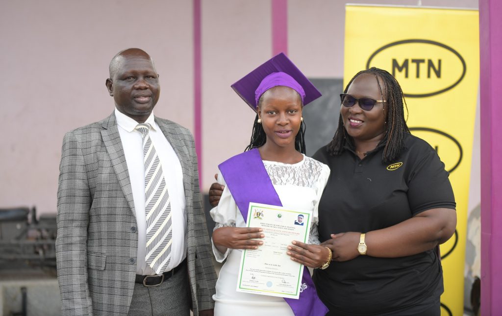 Enid Edroma, General Manager, of Corporate Services at MTN Uganda congratulating one of the graduating girls.