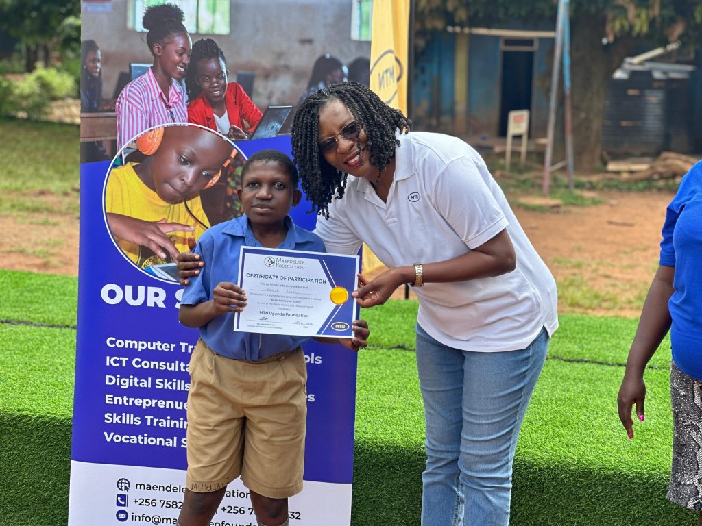 The General Manager for wholesale and carrier services at MTN Uganda Ms. Juliet Nsubuga awards a certificate to one of the pupils at Uganda School for the Deaf who went through ICT training by MTN Uganda CSR arm, MTN Foundation.