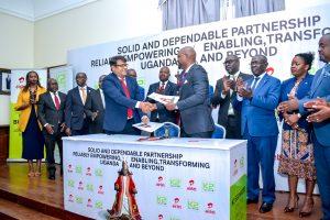 Airtel Uganda's Managing Director, Soumendra Sahu (left) and K2 Telecom's Managing Director, Arthur Mawanda (right) exchange MoUs to renew their partnership while Charles Peter Mayiga (center in the back), the Katikkiro of Buganda and other officials from the Buganda Kingdom, Airtel Uganda, and K2 Telecom look on. Courtesy Photo