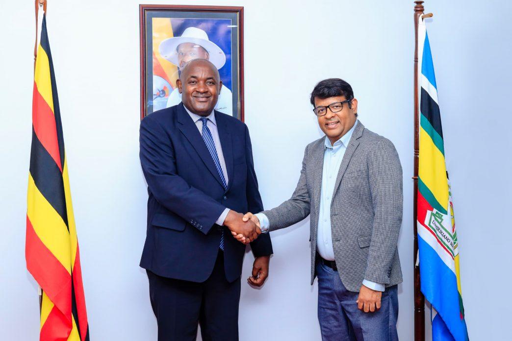 Minister of ICT and National Guidance, Dr. Chris Baryomunsi (left) shakes hands with Soumendra Sahu (right), Airtel Uganda's new managing director. COURTESY PHOTO